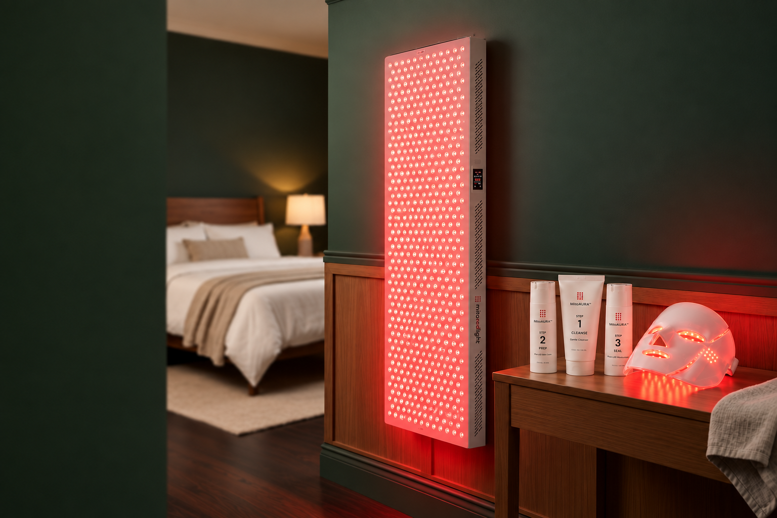 Red-light therapy panel, skincare tubes, and glowing LED face mask beside a bedroom.