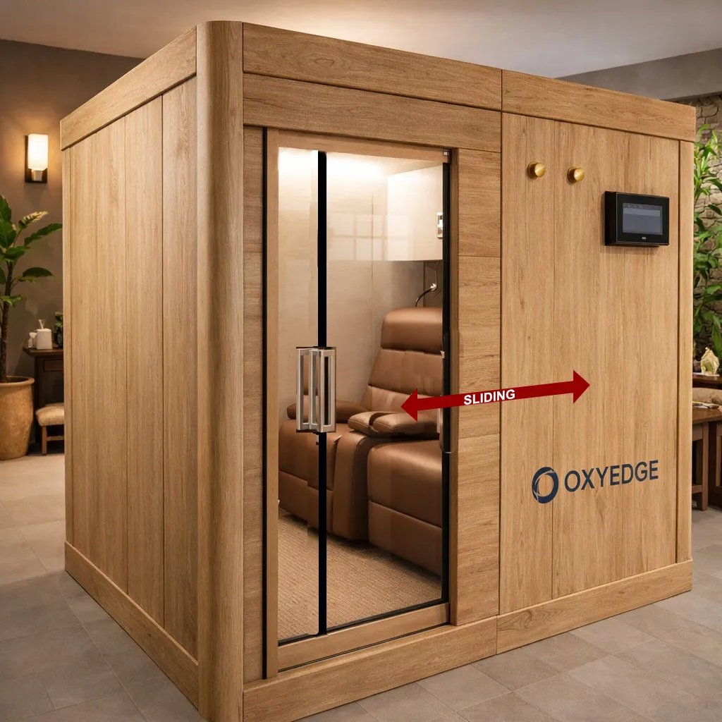 Wood-paneled wellness enclosure with glass sliding door, brown recliner, touchscreen, and OXYEDGE logo.